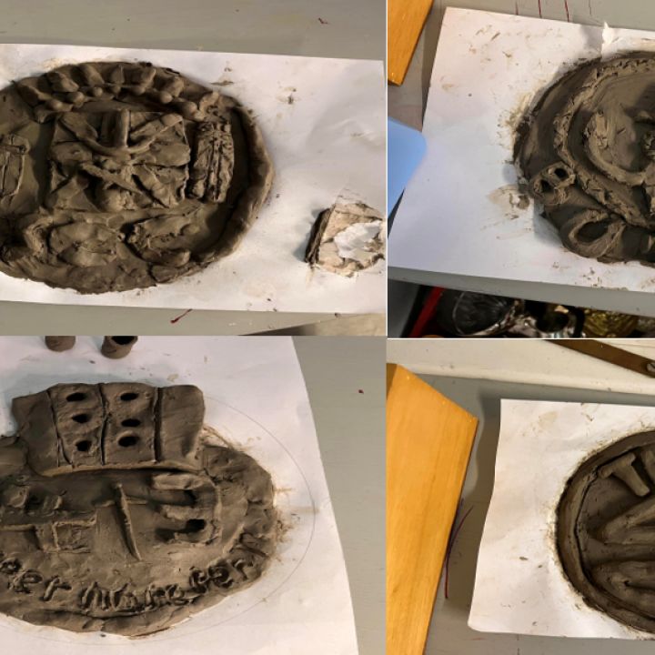 Clay Divisional crests in grid on tables.