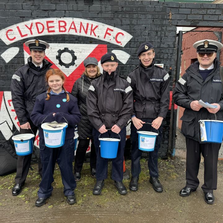 Cadets and staff stand in front of the Clydebank F.C crest.